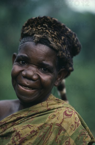 CONGO, Tribal People, Pygmy woman wearing civet skin hat.  Portrait.