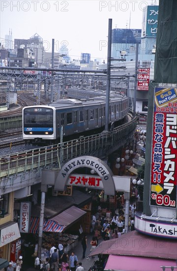 JAPAN, Honshu, Tokyo, View over the busy Ameyayokocho market street and the elevated train tracks above