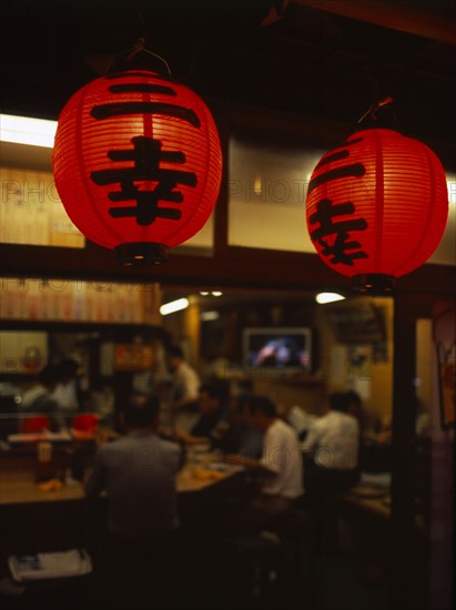 JAPAN, Honshu, Tokyo, Close up view of lanterns illuminated outside an Asakusa area restaurant