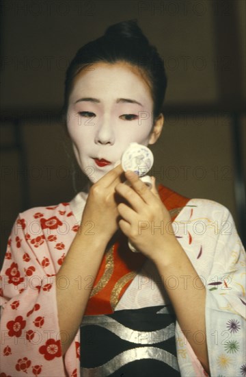 JAPAN, Geisha , Geisha applying white face powder