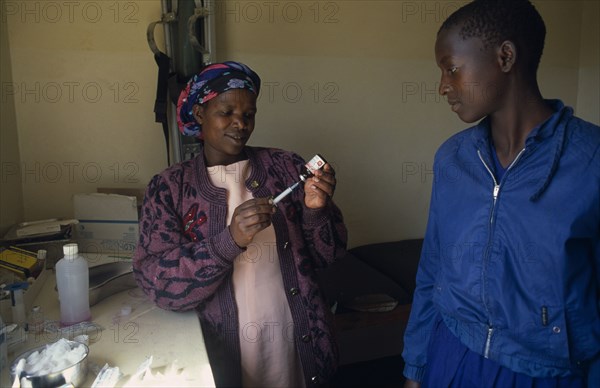 KENYA, Bomet, Female Doctor preparing to give an injection in village clinic