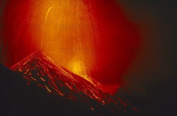 ITALY, Sicily, Volcano Stromboli erupting at night.