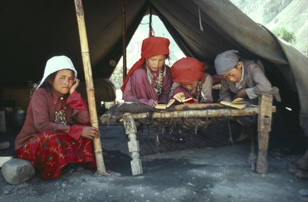 AFGHANISTAN, Reilgion, Islam, Group of Kirghiz children inside tent studying the Koran.