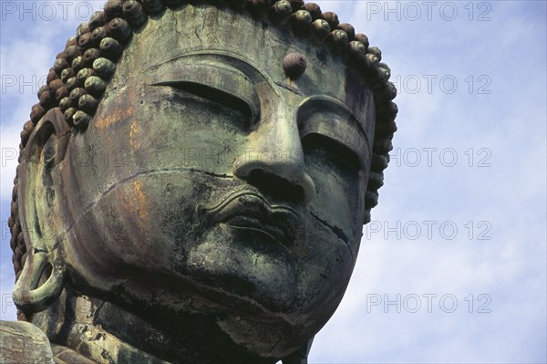 JAPAN, Honshu, Kamakura, Angled view looking up at the head of the Daibutsu aka Great Buddha statue dating from 1252