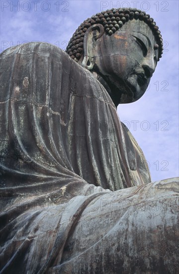 JAPAN, Honshu, Kamakura, Angled view looking up at the Daibutsu aka Great Buddha statue dating from 1252