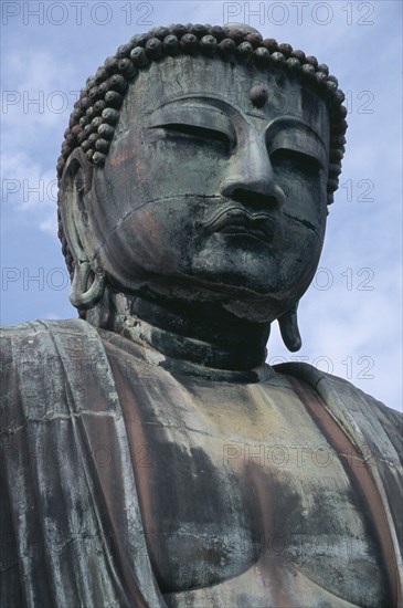 JAPAN, Honshu, Kamakura, Angled view looking up at the head of the Daibutsu aka Great Buddha statue dating from 1252