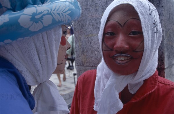 JAPAN, Honshu, Tokyo, Harajuku District. Portrait of two young teenage girls wearing theatrical face makeup