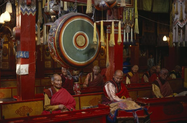 MONGOLIA, Ulaanbaatar, Gandantegchinlen monastery interior with Mongolian Buddhist monks.