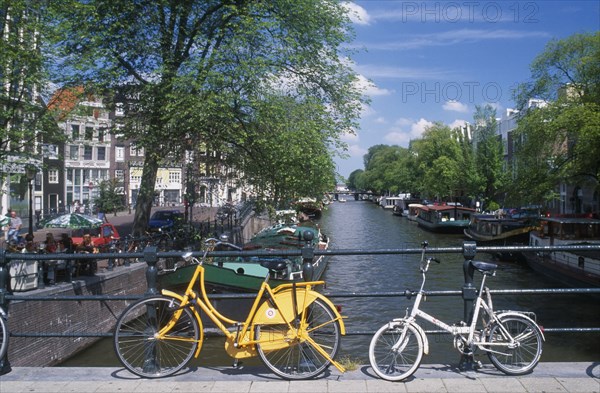 HOLLAND, Noord, Amsterdam, Bicycles leaning against the railings of a bridge over the Keizersgracht canal