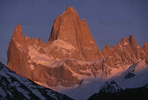 ARGENTINA, Patagonia, Santa Cruz, "Parque Nacional Los Glaciares, Monte Fitz Roy.  Snow lying on peaks and ridges in golden light."