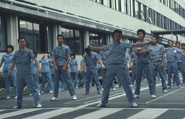 JAPAN, Honshu, Osaka, Matsushita Electrics company workers performing exercises