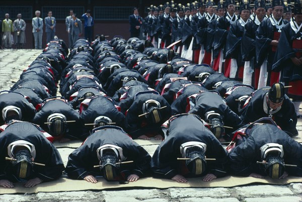 SOUTH KOREA, Seoul, Ching Myo Temple Confucian rites ceremony with worshippers prostrating to the ground.