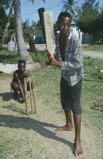 CARIBBEAN, Jamaica, Clarendon, Two boys playing cricket