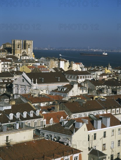 PORTUGAL, Lisbon, Bairro Alto, View over city rooftops toward The Se Cathedral and River Tagus from the Parque San Pedro Alcantara.