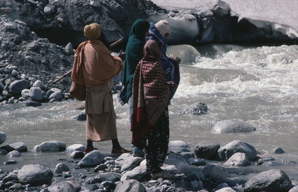 INDIA, Uttar Pradesh, Garhwal Region, Pilgrims bathing in snow melted water at Gormuich the Cows Mouth one of the sources of the Ganges