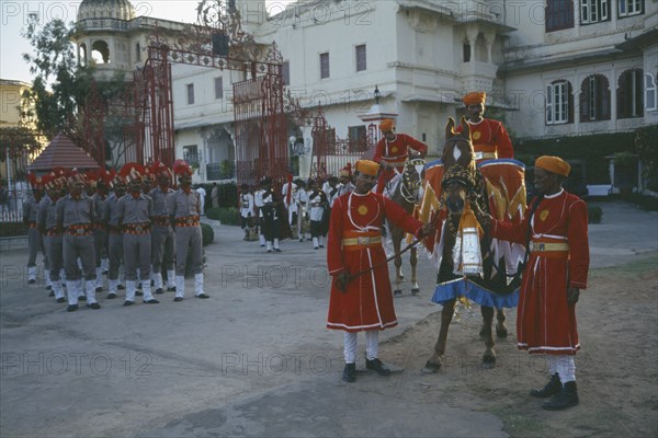 INDIA, Rajasthan, Udaipur, "The City Palace complex.  Shambhu Niwas Palace, present residence of the Maharana or Rajput clan head.  Courtyard with parade of private guards and horses."