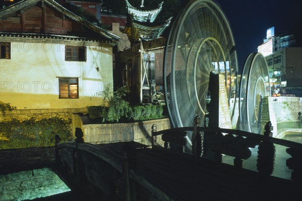 CHINA, Yunnan, Lijiang, Waterwheel at night.