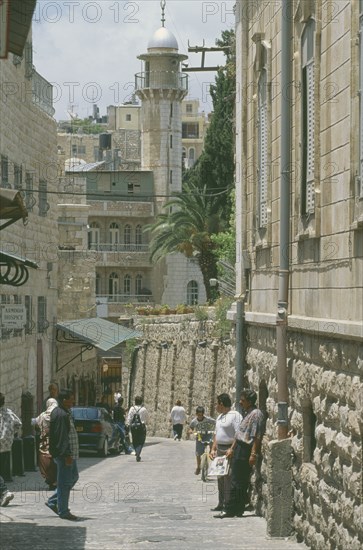 ISRAEL, Jerusalem, Old City East, Via Dolorosa narrow street lined with shops. Aka The Way of Suffering. Said to be the route that Jesus carried his cross to the crucifixtion site