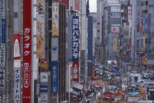 JAPAN, Honshu, Tokyo, Okachimachi. View along advertising signs covering the architecture of a busy city street