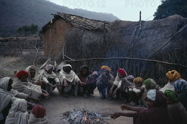 20060679 INDIA  People Village elders in conference seated in circle around fire.