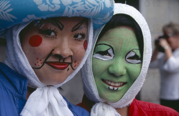 JAPAN, Honshu, Tokyo, Harajuku District. Portrait of two smiling girls wearing face paint