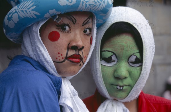 JAPAN, Honshu, Tokyo, Harajuku District. Portrait of two girls wearing face paint