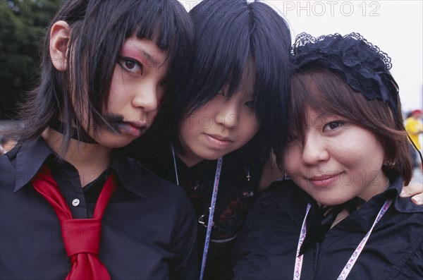 JAPAN, Honshu, Tokyo, Harajuku District. Portrait of three girls dressed in teenage Japanese style