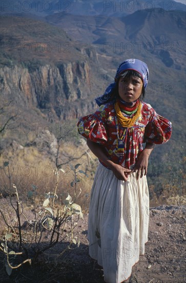 MEXICO, Sierra Huichol, Young Huichol girl in mountain landscape.