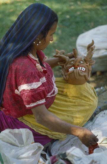 MEXICO, Festivals, Woman making clay figure for Day of the Dead.