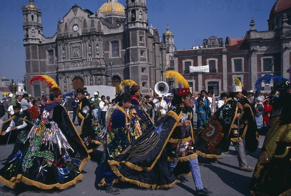 MEXICO, Mexico City, Celebrations for Our Lady of Guadaloupe outside the Basilica with dancers in costume.