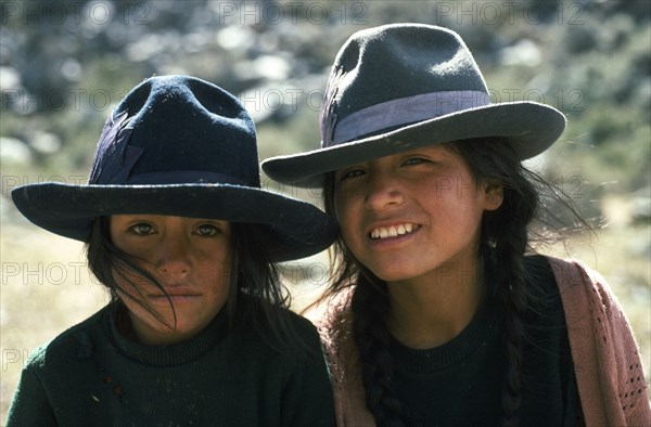 PERU, Ancash, Cordillera Blanca, Head and shoulders portrait of two girls from Quebrada Quilcayhuanca.