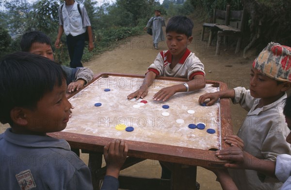 NEPAL, Dhankuta Region, Children, Limbu boys playing Karem board game.