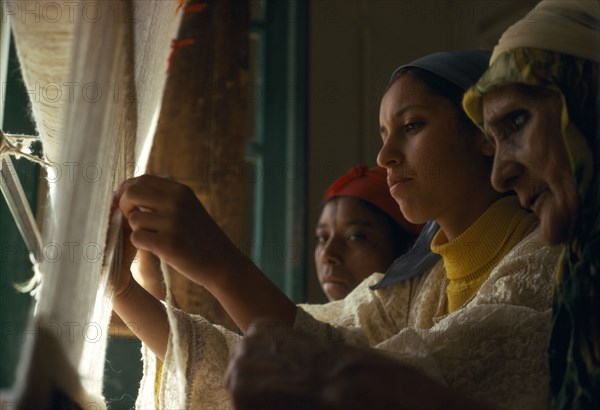 MOROCCO, Weaving, Women making carpet on hand loom.