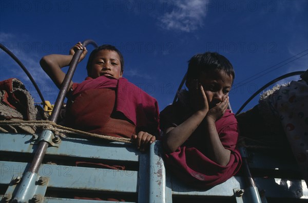 20061025 TIBET  Lhasa Novice monks looking down from back of truck.