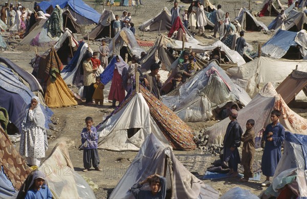 PAKISTAN, North West Frontier Province, "UNHCR camp for refugees from Afghanistan.  Crowded tents, men, women and children."