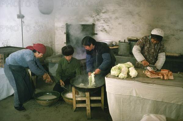 CHINA, Food Perparation, Preparing and cooking meat and vegetables in kitchen of comune.