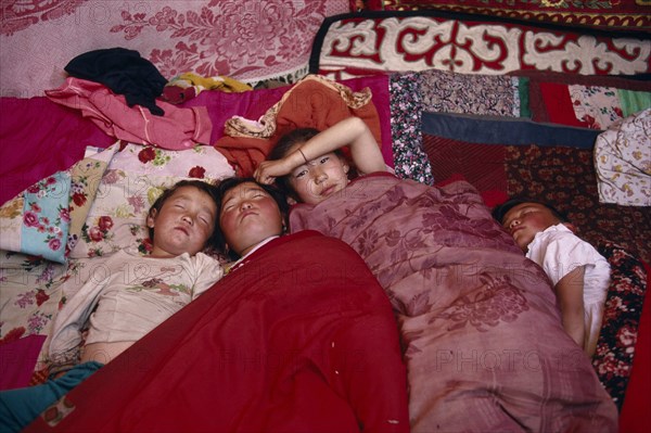 20061225 CHINA Xinjiang Province Altai Mountains Kazakh children asleep in their kigizuy tent made of felt.