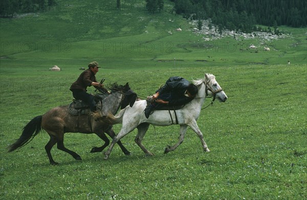 CHINA, Xinjiang Province, Traditions, Kazakh traditional wrestling on horseback called Audaryspak performed at weddings and festivals.