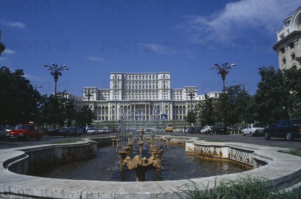 ROMANIA, Bucharest, House of the Republic.  Palace of former Communist president Nicholae Ceausescu.  Exterior facade with pool and fountain in the foreground.