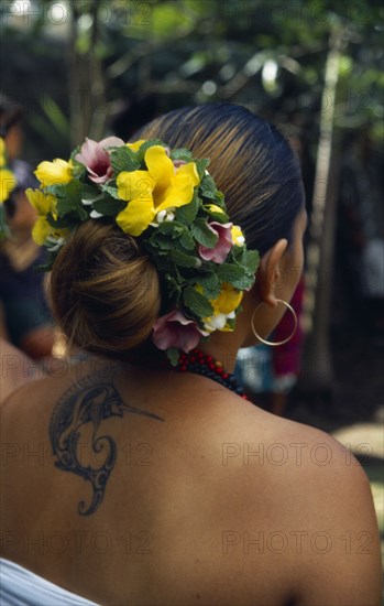 PACIFIC ISLANDS, Polynesia, French Polynesia, "Marquesas Islands.  Ua Huka.  Dancer wearing umuhei head dress of mint, hibiscus and frangipani flower and with tattoo of swordfish between her shoulder blades."