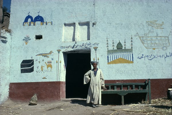 EGYPT, Gaziret Quoma, Muslim man who has painted his pilgrimage to the Haj on his home