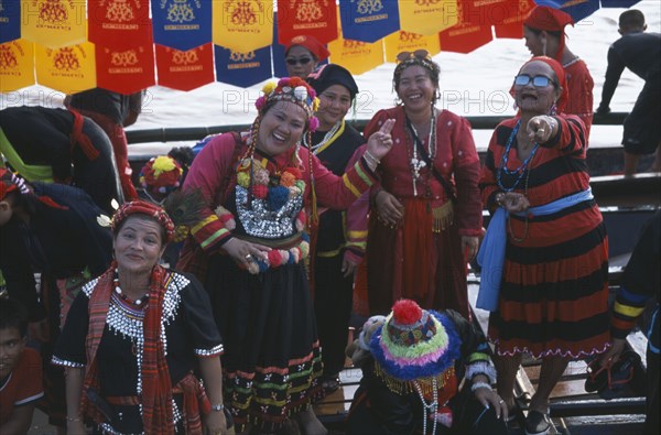 LAOS, Vientiane, Group of women spectators at boat races on the Mekong River.