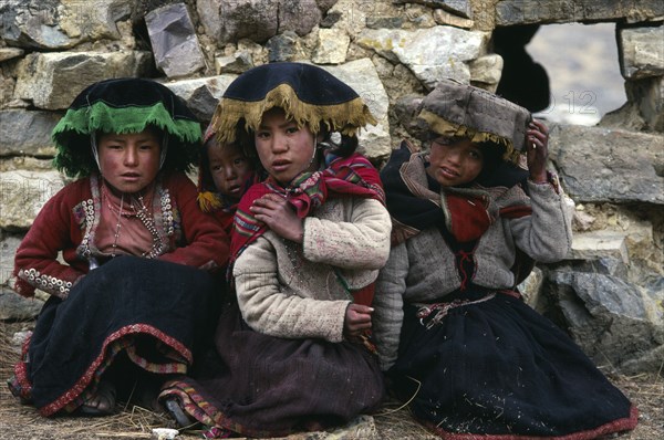 PERU, Cusco, Cordillera Vilcanota, Portrait of three young girls from Pacchanta at the foot of Nevado Auzangate.