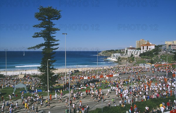 AUSTRALIA, New South Wales, Sydney, Bondi Beach.  Competitors and spectators in annual City to Surf race.
