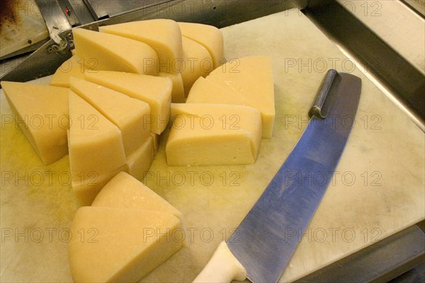 USA, Minnesota, St Paul, "Wedges of freshly cut Park brand Parmesan Cheese from Wisconsin at the Mississippi Market a natural foods co-op located at Dale and Selby, waiting to be wrapped, weighed and packaged."