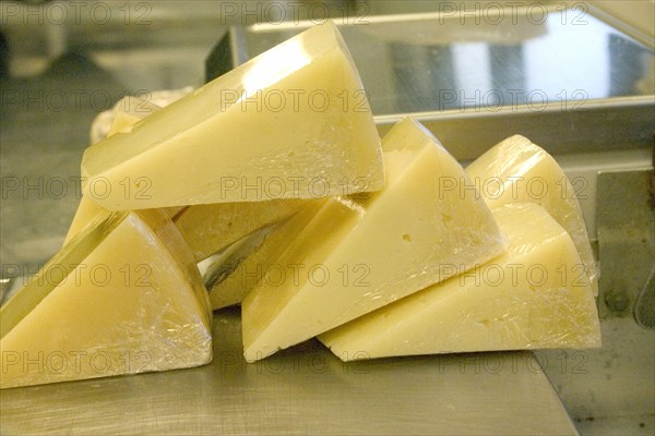 USA, Minnesota, St Paul, Wrapped wedges of Park brand Parmesan Cheese from Wisconsin ready to be weighed and priced at the Mississippi Market a natural foods co-op located at Dale and Selby.
