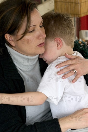 USA, Minnesota, St Paul, Mother comforting son after a playtime incident.