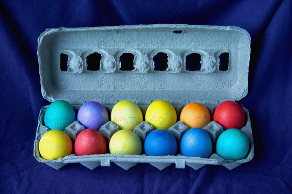 USA, Minnesota, St Paul, A dozen dyed Easter eggs in a carton.