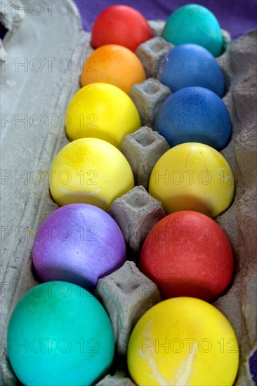 USA, Minnesota, St Paul, A dozen dyed Easter eggs in a carton.