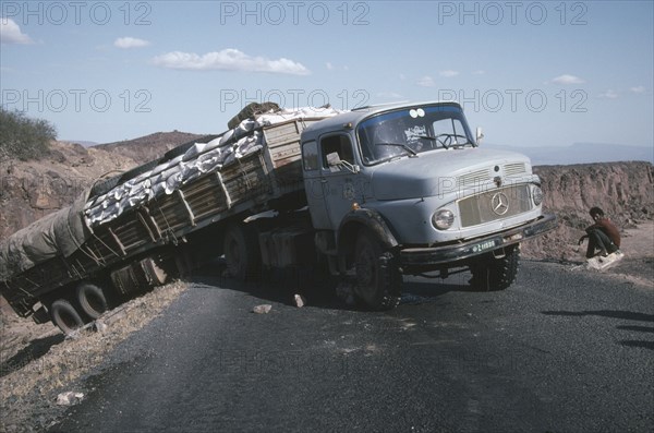ETHIOPIA, Transport, World Food Programme lorry with trailer having slipped off the road